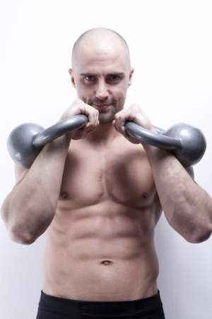 bodybuilder-standing-holding-kettle-bell-weights