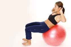 woman-doing-abs-cruches-on-exercise-ball-end-position