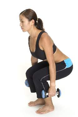 woman-doing-dumbbell-squats-middle-position