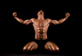 bodybuilder-flexing-and-kneeling-looking-up